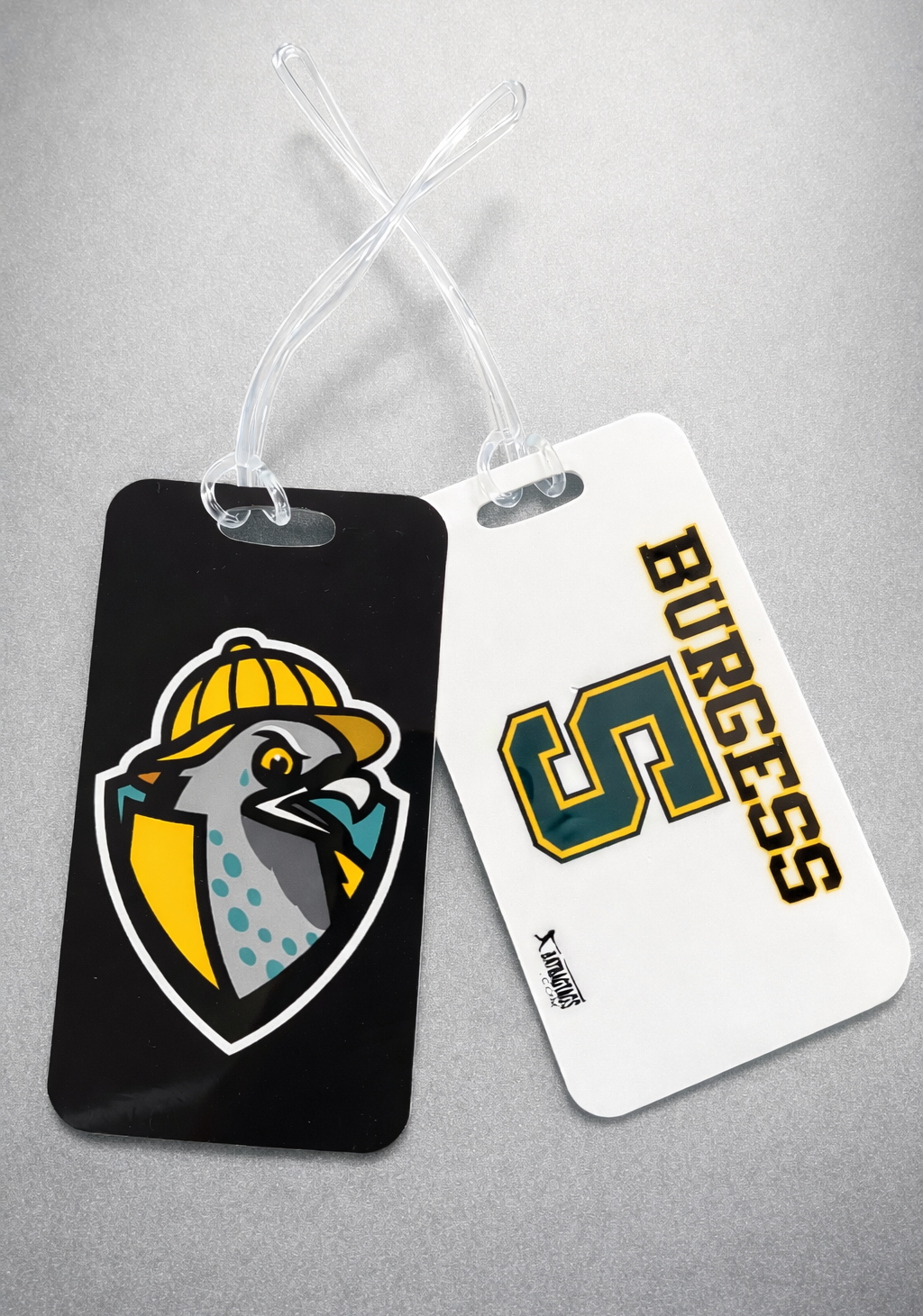 Two luggage tags with a logo and text on a gray background