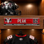 A football helmet and black jersey with red and white accents are displayed inside a wooden locker. A personalized nameplate on the shelf reads PEAK 82 with FAITH ACADEMY FOOTBALL and a ram logo.