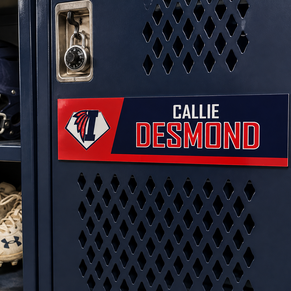 A close-up of a navy blue metal locker door with a custom nameplate reading CALLIE DESMOND in white and red, alongside an Illinois 'I' logo. Inside the locker, a navy helmet with an 'I' logo, white cleats, and a yellow softball are stored on shelves.
